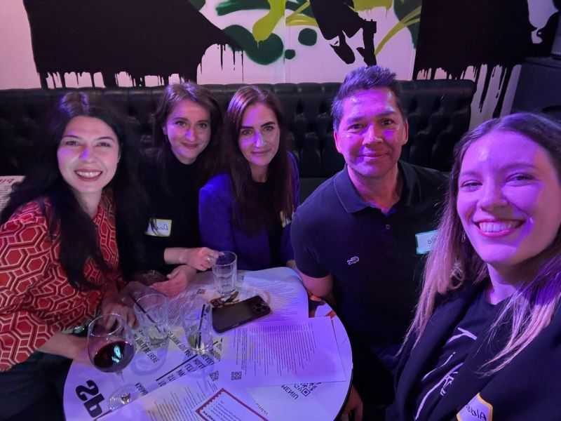 Eric Melchor with guests around a table at the 3rd Space Bucharest launch party at Make It Monkey