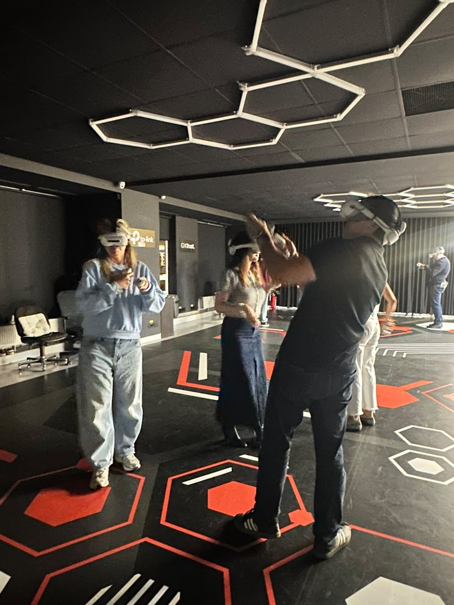 AI Circle members playing a VR escape room in headsets at Gateway VR Studio in Bucharest