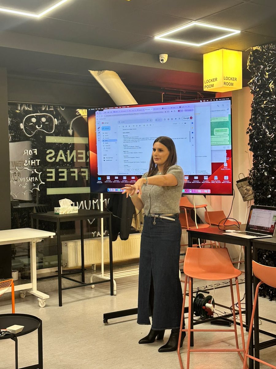 An AI Circle member presenting the email-and-calendar workflow she built with Claude, shown on a large screen