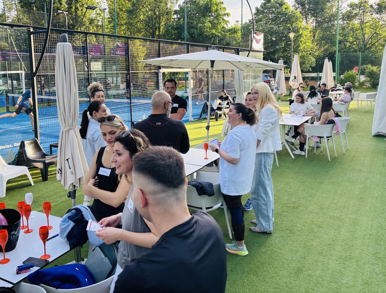 Guests gathered on the terrace between padel matches in Bucharest