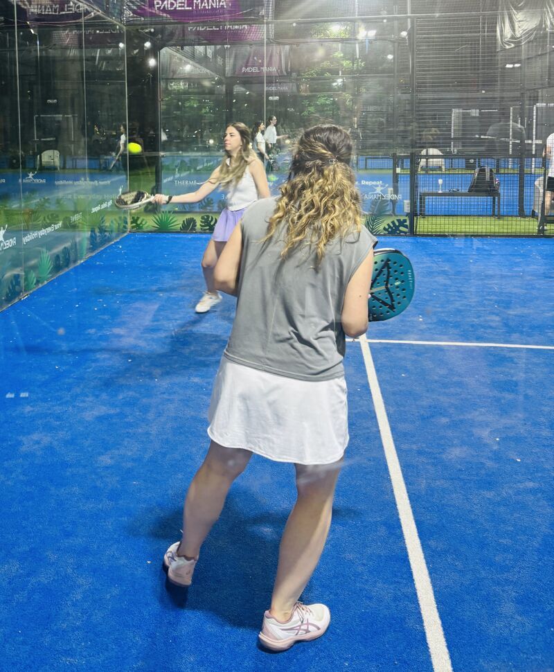 Two guests playing a padel rally at the Padel & Prosecco night in Bucharest