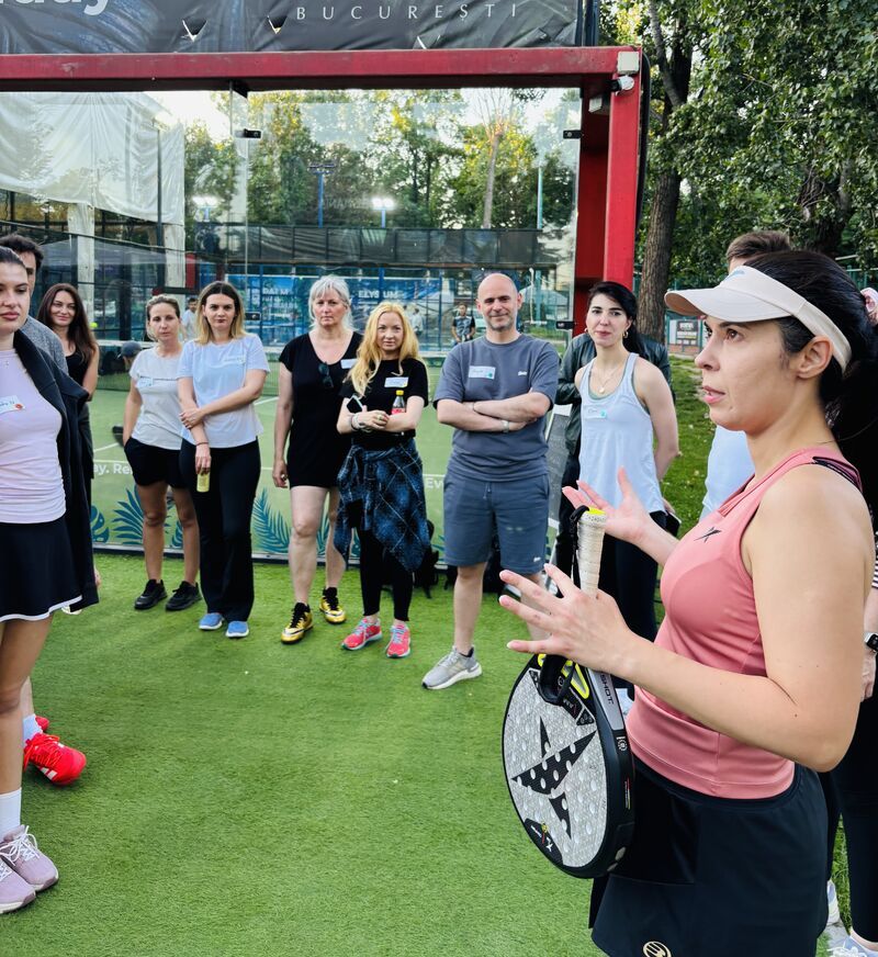 Guests listening to a padel coach at a 3rd Space Bucharest padel social