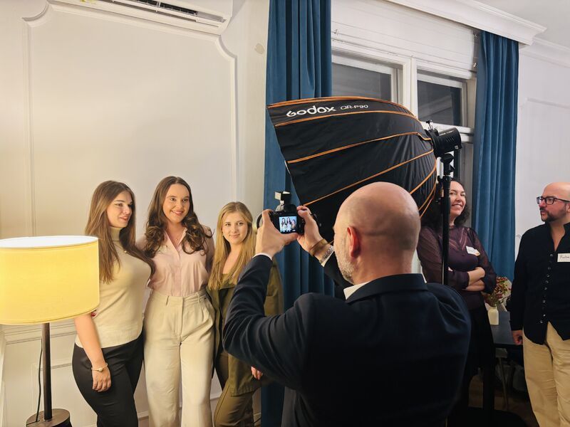 A photographer taking headshots of guests at Portraits & Prosecco in Bucharest