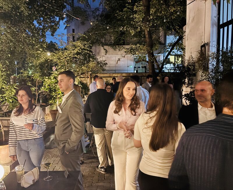 Guests mingling in the A46 courtyard at Portraits & Prosecco