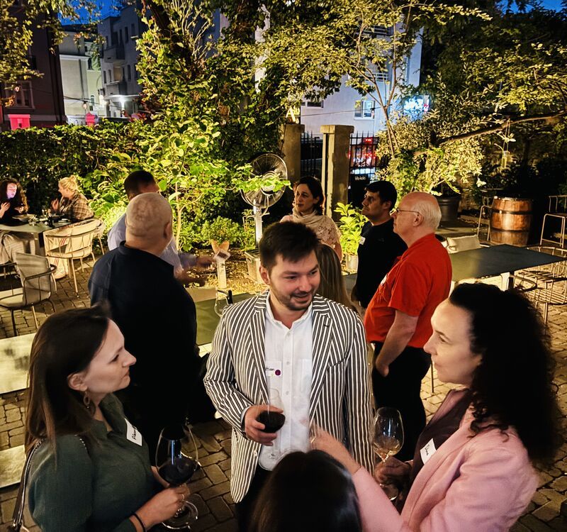 Guests under string lights in the A46 courtyard in Dorobanți