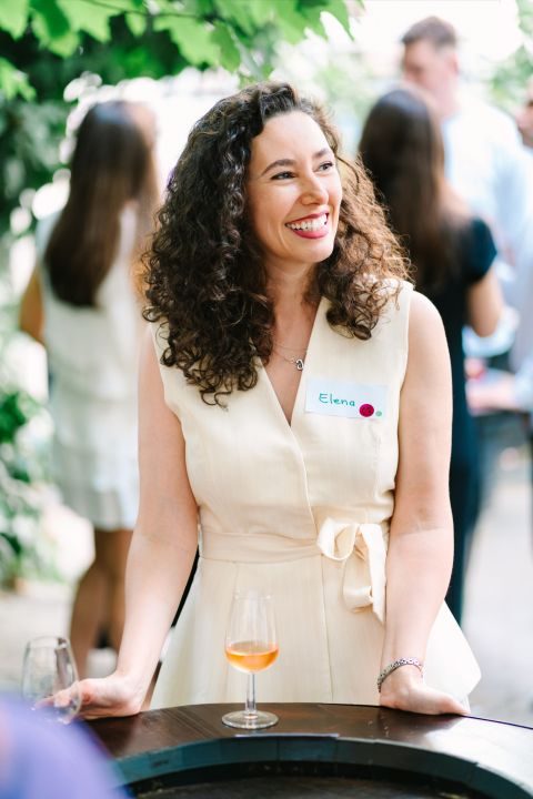 A guest laughing beside a glass of rosé at the 3rd Space Bucharest wine social