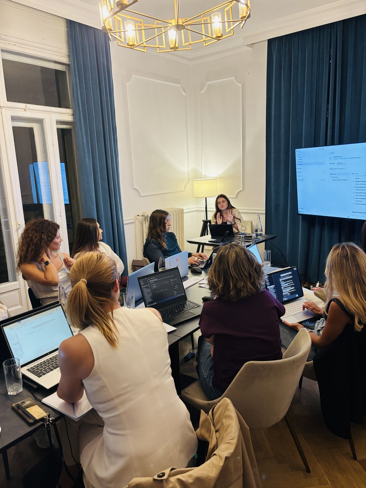 Ana Toniuc walking the group through a Claude skill on the big screen at an AI Circle night in Bucharest